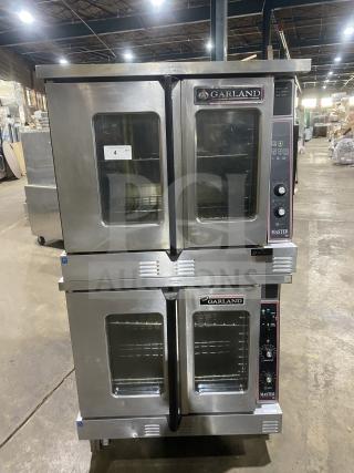 Garland Master 300 stainless steel double stacked convection oven, natural gas powered, view-through doors, wire racks, on casters.