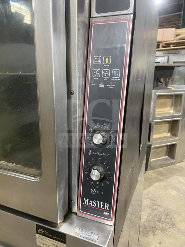 Garland Master 300 double-stacked convection oven, stainless steel, view-through door, wire racks, on casters, good condition.