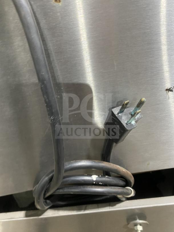 Auction item: Garland Master 300 double-stacked convection oven plug and power cord, stainless steel, natural gas, on casters.