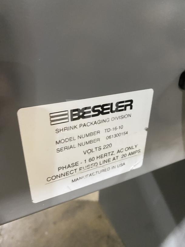 Beseler shrink wrap system label showing model TD-16-10, SN: 061300154, 220V 1 Phase, manufactured in USA.