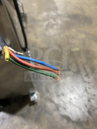 Stainless steel vacuum syrup filter press with exposed colored wires, signs of wear; ideal for commercial syrup processing.
