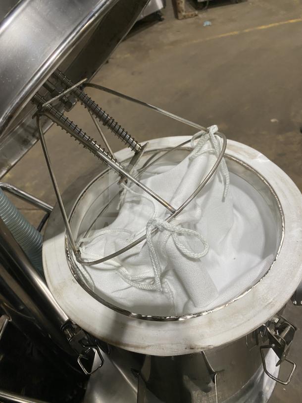 Commercial stainless steel vacuum syrup filter press canister, features white filter bag. Used condition.
