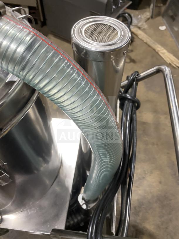 Commercial stainless steel vacuum syrup filter with hose attachment, excellent condition, features durable canister design.