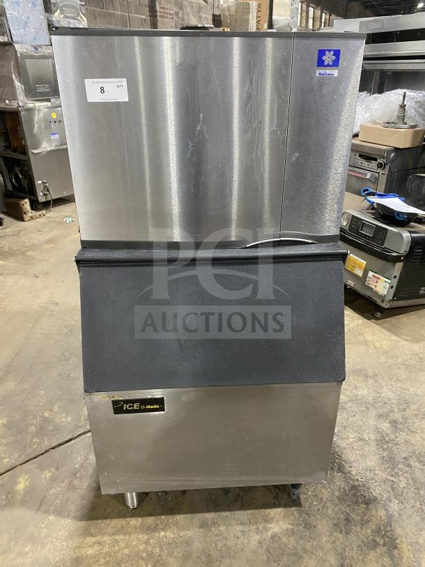 Manitowoc SD0452A commercial stainless steel ice-making machine and bin combo, electric powered, lift open access, on legs.