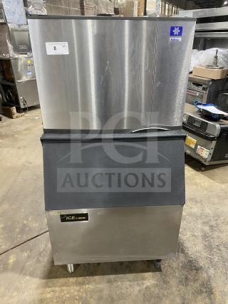 Manitowoc SD0452A commercial stainless steel ice-making machine and bin combo, electric powered, lift open access, on legs.