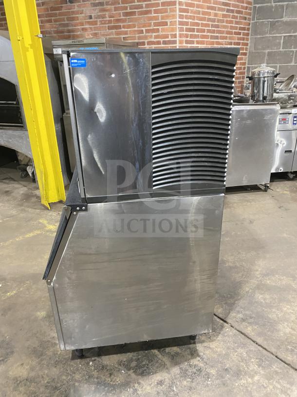 Manitowoc SD0452A commercial ice maker/bin combo, stainless steel, electric, with lift open access, on legs.