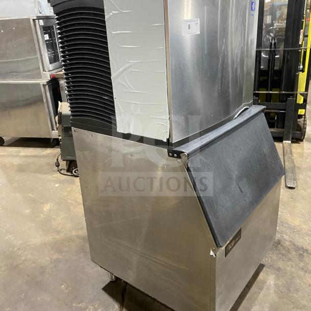 Manitowoc SD0452A ice making machine/bin combo on legs. Stainless steel, electric-powered, lift-open access, commercial use.