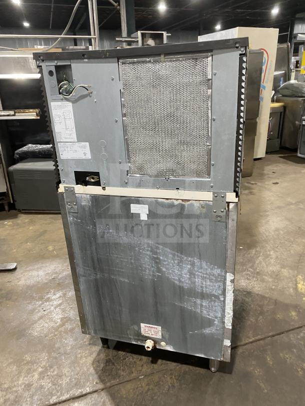 Manitowoc SD0452A stainless steel commercial ice making machine/bin combo on legs. Features lift open access. Visible wear.