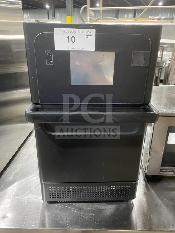 MerryChef black electric high-speed rapid cook oven, countertop model, good condition, visible touch controls, auction tag.