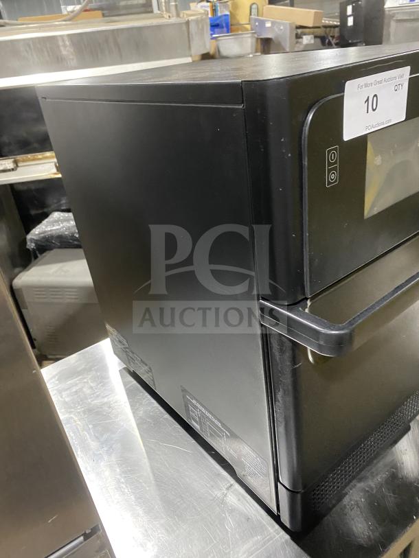MerryChef countertop high-speed oven, black, electric-powered, good condition, visible control panel, auction tag attached.