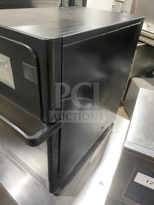 MerryChef black electric countertop high-speed rapid cook oven in good condition, with a sleek design.