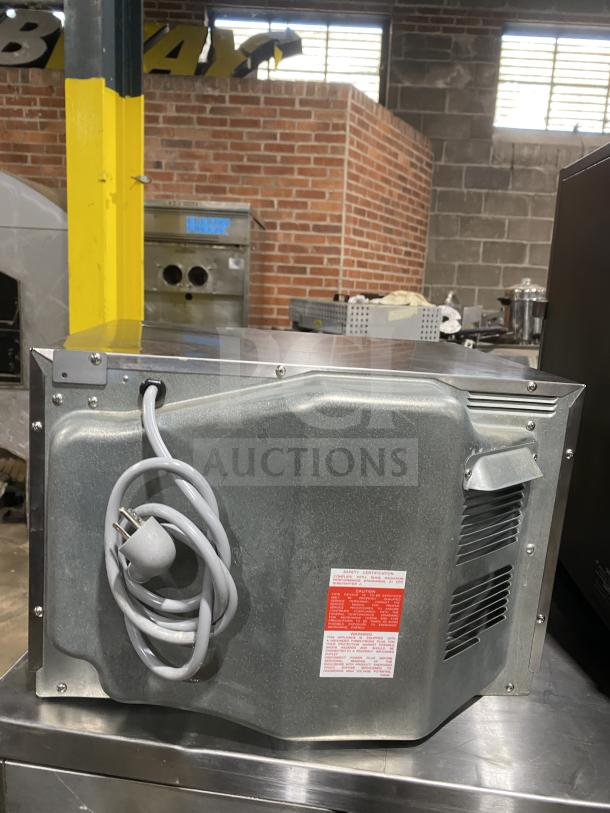 Sharp R-22GT-F commercial stainless steel microwave, visible rear view with power cord. Features digital control, 120V.