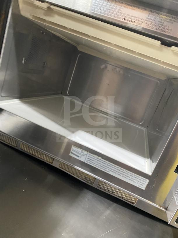 Sharp R-22GT-F stainless steel commercial microwave oven with digital controls, 120V, excellent condition, interior view.