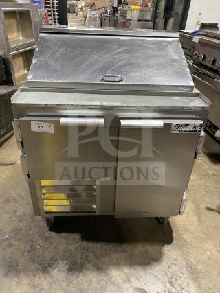 Leader LM36 S/C stainless steel refrigerated sandwich prep table on casters, 115V, with vented front and branded label.