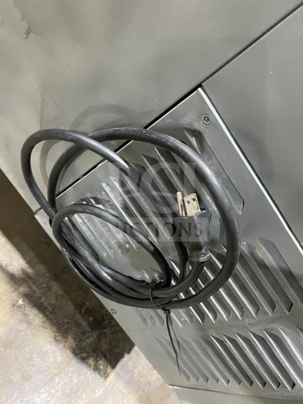 Leader LM36 S/C refrigerated sandwich prep table, stainless steel, 115V 1 Phase, on casters, visible power cord.