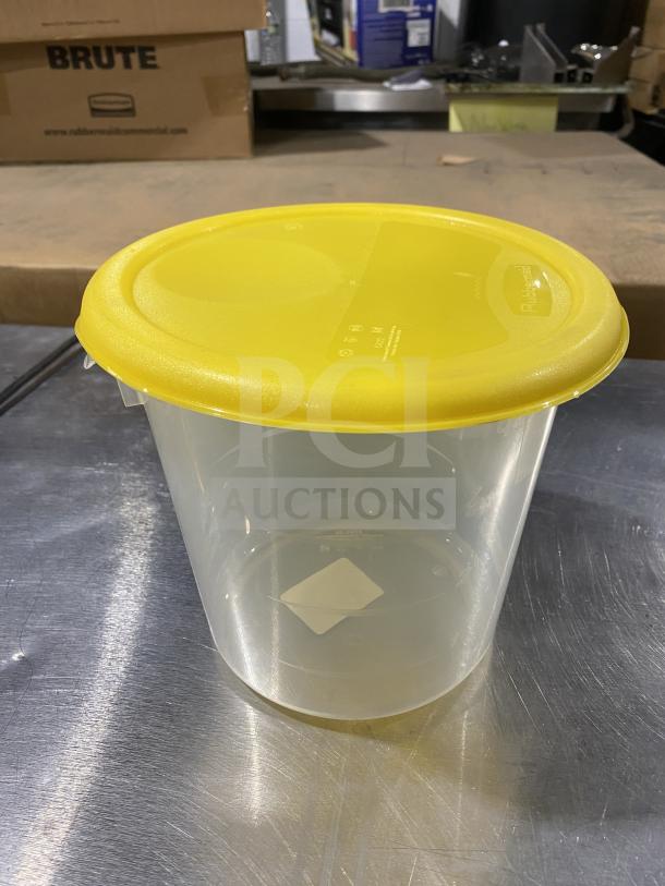 Rubbermaid commercial round storage container with yellow lid. Clear plastic, excellent condition. Volume markings visible.