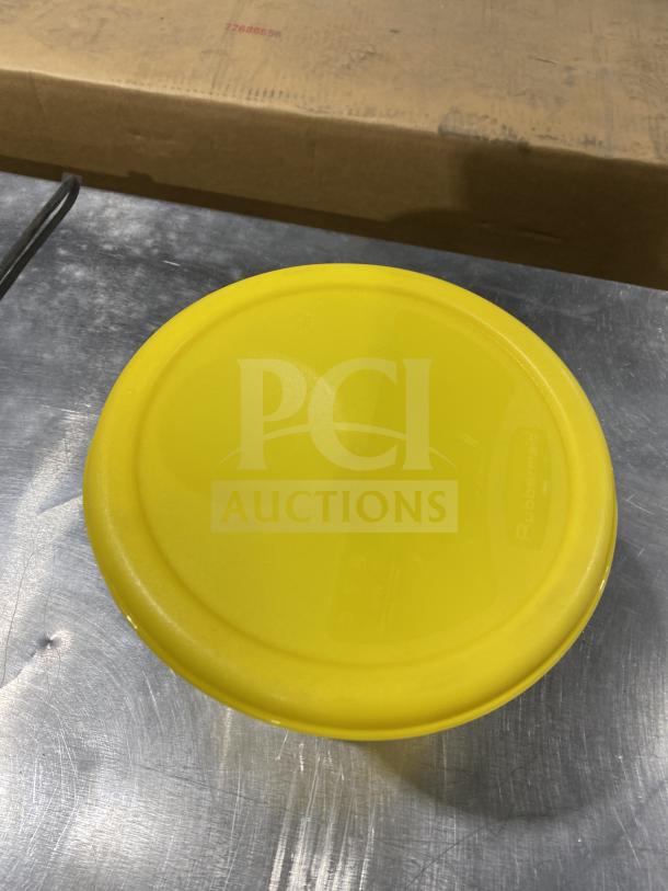 Rubbermaid round storage container with yellow lid, commercial grade, durable condition. Visible brand marking on lid.