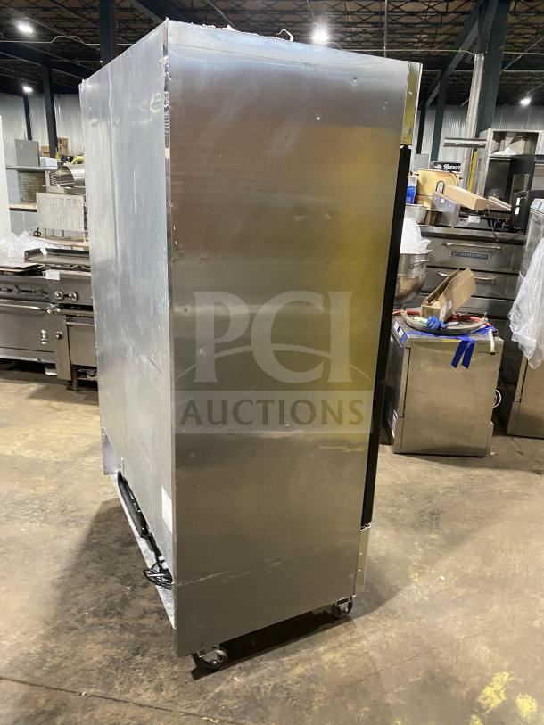 Atosa MCF8707 commercial stainless steel double glass door reach-in merchandiser refrigerator, on casters, side view.