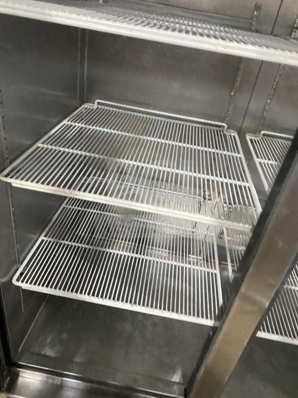 Atosa MCF8707 commercial refrigerator; double glass doors, poly coated wired rack, on casters, stainless steel finish.