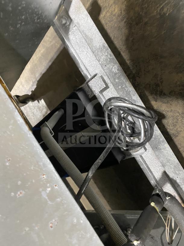 Atosa MCF8707 commercial refrigerator with stainless steel body, double glass swing doors, poly-coated wired rack, and casters.