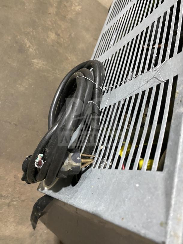 Close-up image of a power cord and metal grill of a Beverage Air SP27 refrigerated prep table. Visible wear on cord.