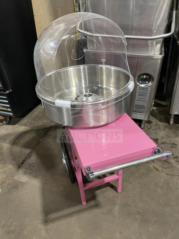 Olde Midway Spin-2000 cotton candy machine/cart in hot-pink with stainless steel 20" bowl, clear dome, on wheels. Model SN: 5002274.