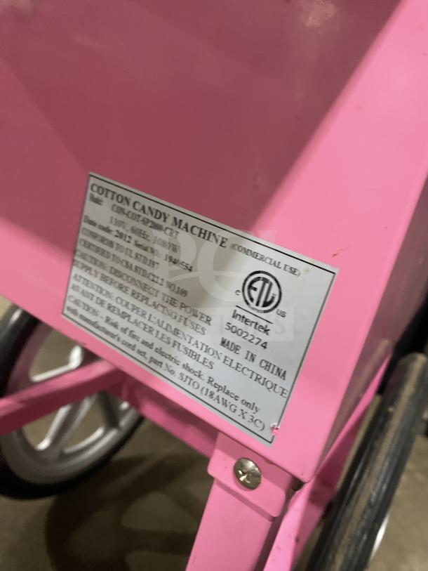 Olde Midway Spin-2000 hot-pink cotton candy machine on wheels, stainless steel bowl, clear dome lid, model SN: 5002274.
