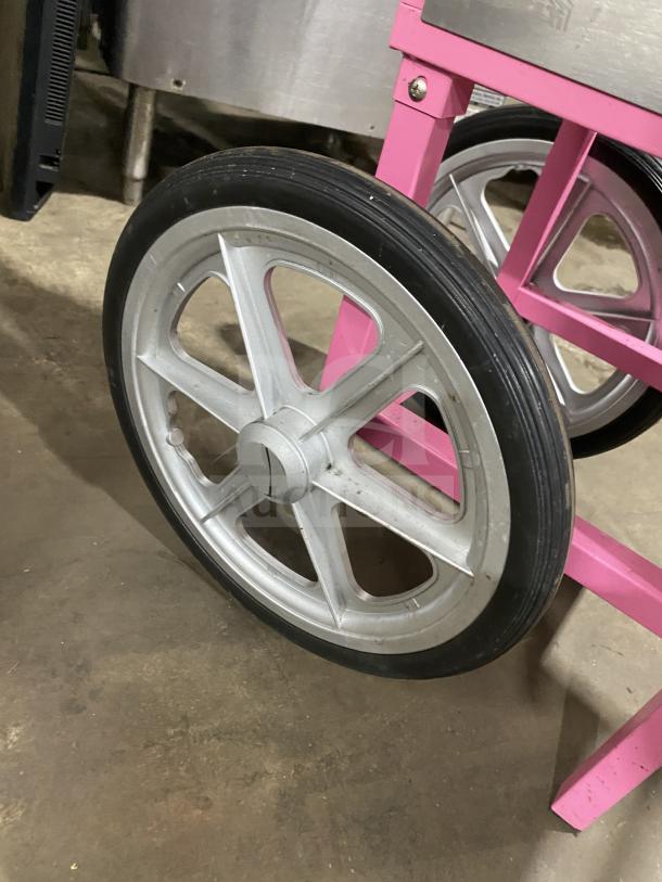 Olde Midway Spin-2000 Series cotton candy machine wheel, hot-pink frame, large silver wheel, stainless steel background.