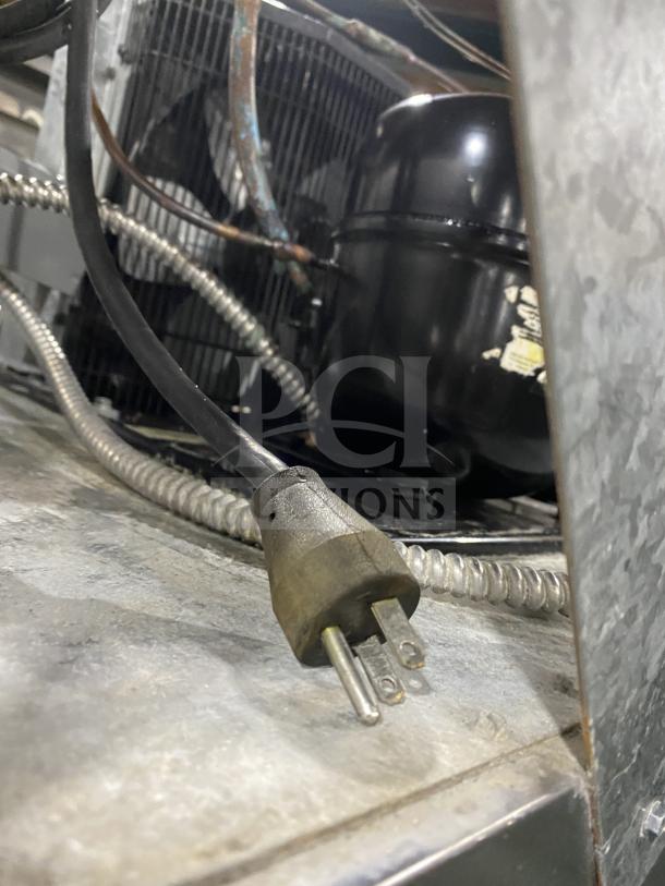 Victory stainless steel single door refrigerator, 115V, commercial-grade, visible electrical components, needs cleaning.