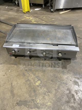 Cecilware Pro Series stainless steel gas countertop griddle with back and side splash, on legs. Visible wear.