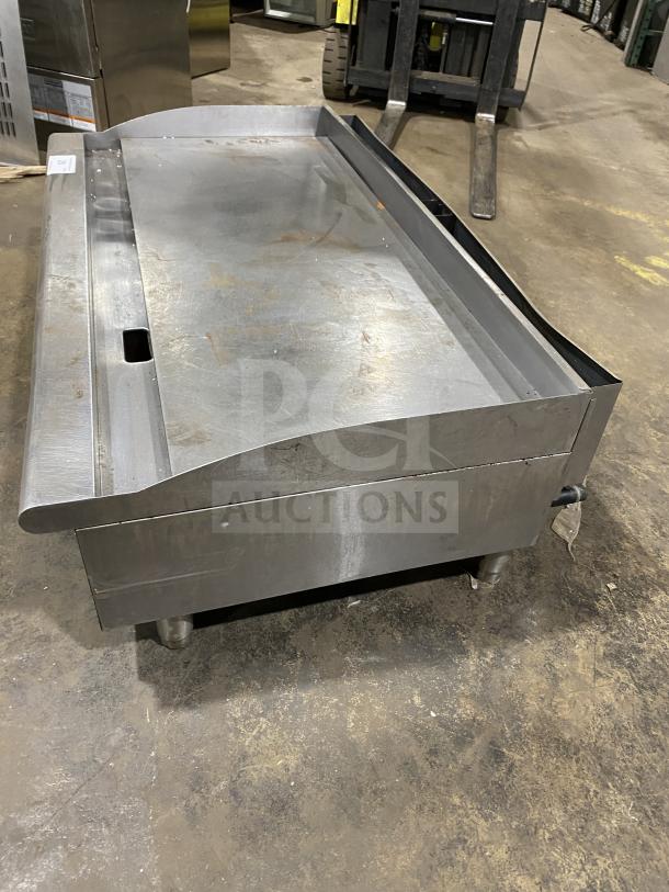 Cecilware Pro Series stainless steel natural gas flat griddle, with back and side splash, on legs, commercial use.