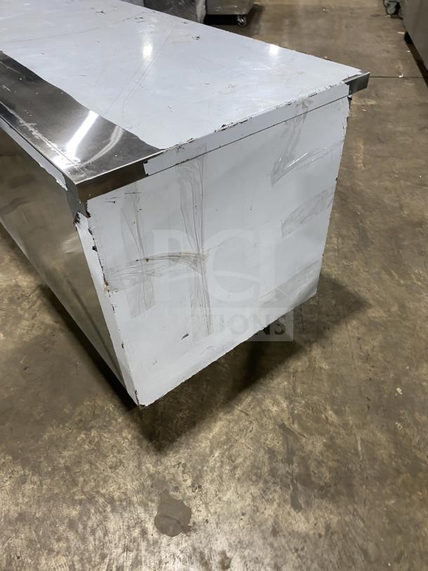 Customcool Model LB93SE commercial stainless steel white prep table, refrigerated, on casters, 115V 1 phase. Visible wear.