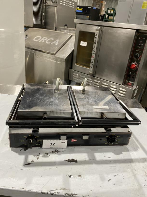 Ceciware commercial electric double panini press, model TSG-2G, in used condition. Features adjustable temperature dials.
