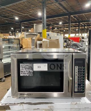 Menumaster RFS12TSW commercial stainless steel microwave oven with digital controls, good condition, 120V, visible auction and info labels.