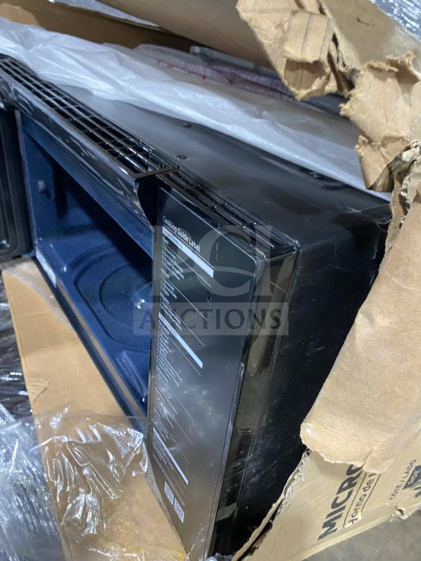 New Samsung stainless steel countertop microwave, model ME213706BAG, in box. Features and cooking guide label visible.