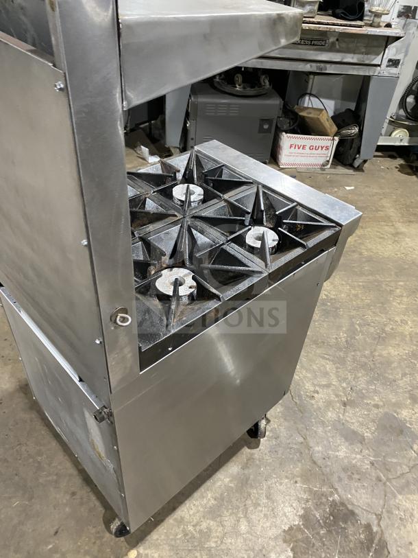 Southbend S241E stainless steel natural gas 4-burner range/oven combo on casters, with backsplash, overhead, and wired oven rack.