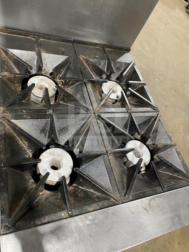 Southbend S241E commercial stainless steel 4-burner range/oven with back splash, overhead rack, casters; used condition.