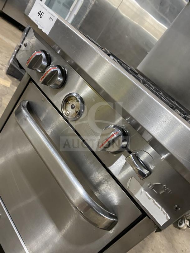 Southbend S241E commercial stainless steel 4-burner range/oven, natural gas, with back splash and overhead, on casters.