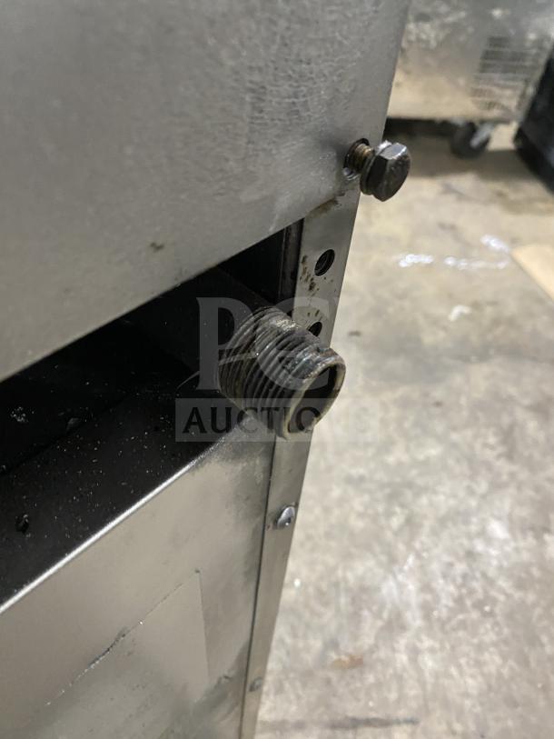 Close-up of a Southbend S241E range/oven showing a natural gas connection pipe and stainless steel body on casters.