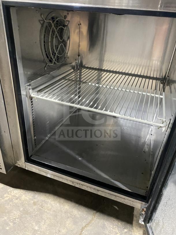 Turbo Air JUR-36 single door undercounter refrigerator, stainless steel, poly-coated rack, side mounted compressor, model tag visible.