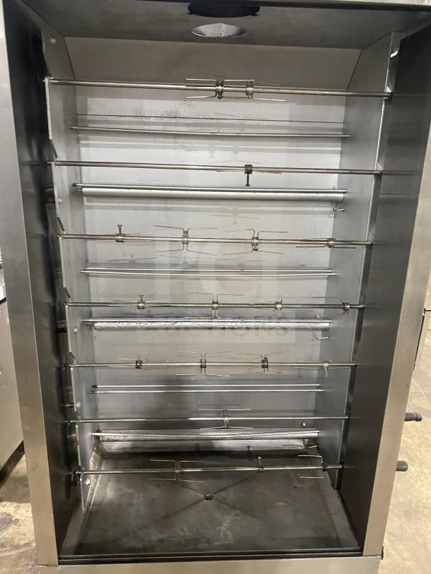 Attias commercial stainless steel rotisserie cabinet, gas-powered, full-height, on casters. Multiple spits, clean condition.