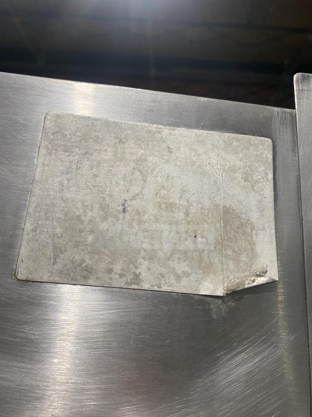 Attias commercial stainless steel rotisserie cabinet, gas-powered, full-height, on casters. Worn label visible, likely detailing specs.