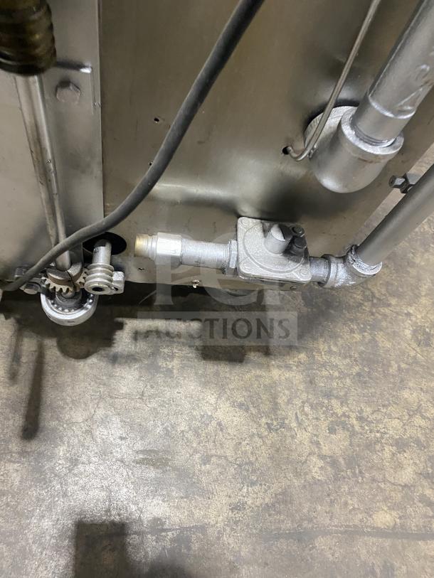 Attias commercial stainless steel gas rotisserie cabinet on casters, features visible gas fittings. Good condition.