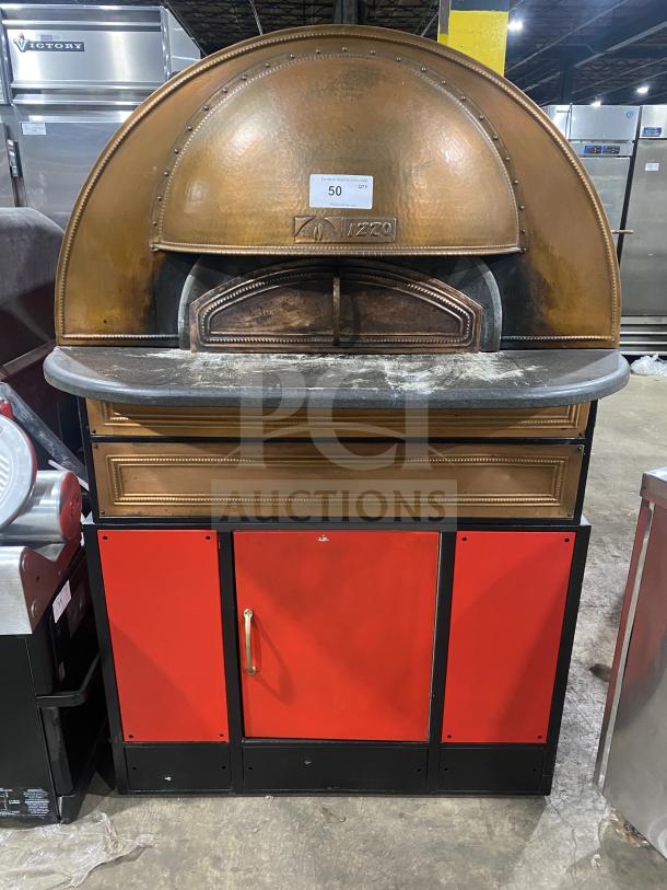 Izzo Forni red electric dome-style pizza oven in good condition, with wooden pizza paddle included; features distinctive branding.