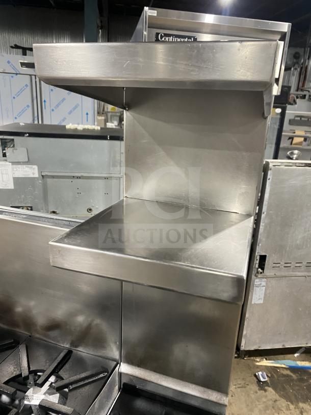 Jade Range 8-burner stainless steel gas range with 2-drawer chef base, back splash, and flue riser. Model TRLH-02S-T-48.