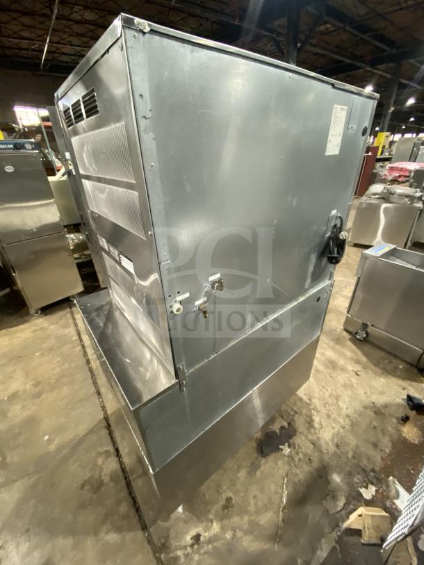Kold Draft C81064LC commercial ice machine on bin, stainless steel, on legs, 208/230V, visible wear, industrial setting.