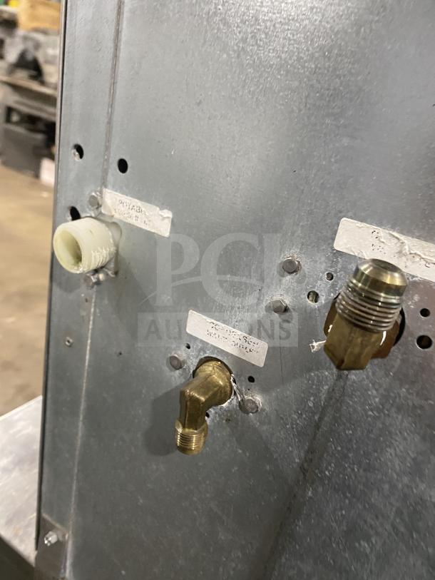 Kold Draft commercial ice machine model C81064LC, stainless steel, on bin with legs, 208/230V, visible pipe fittings.