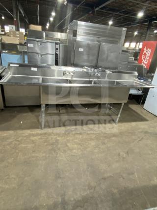 Stainless steel 3-compartment sink by KCS, commercial-grade, on legs, excellent condition, with integrated faucets.