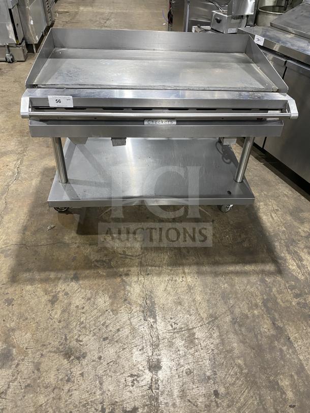 Vulcan stainless steel gas flat griddle with back and side splash, on casters, with undershelf equipment cart, model Checkers.