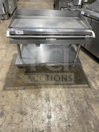 Vulcan stainless steel gas flat griddle with back and side splash, on casters, with undershelf equipment cart, model Checkers.